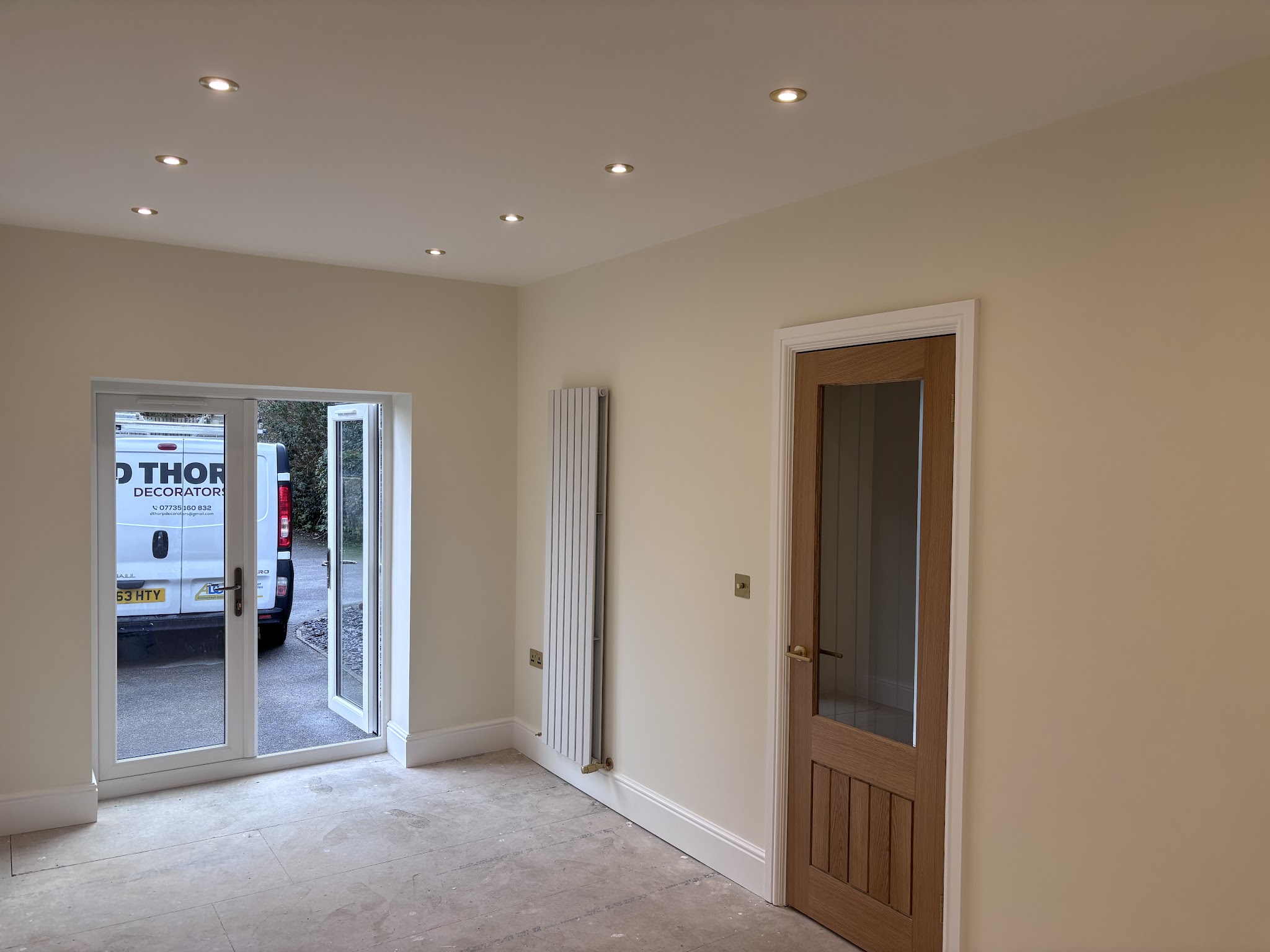 A freshly decorated cream room, with the D Thorp Decorators van visible outside